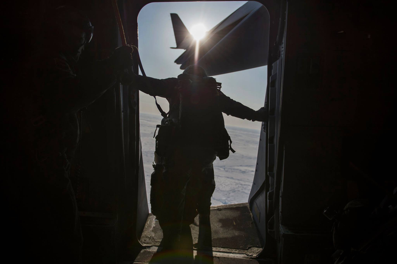 Illustration for article titled Check Out These Shots Of A C-17 Dropping Pararescuemen Over The Navy's Arctic OutpostÂ